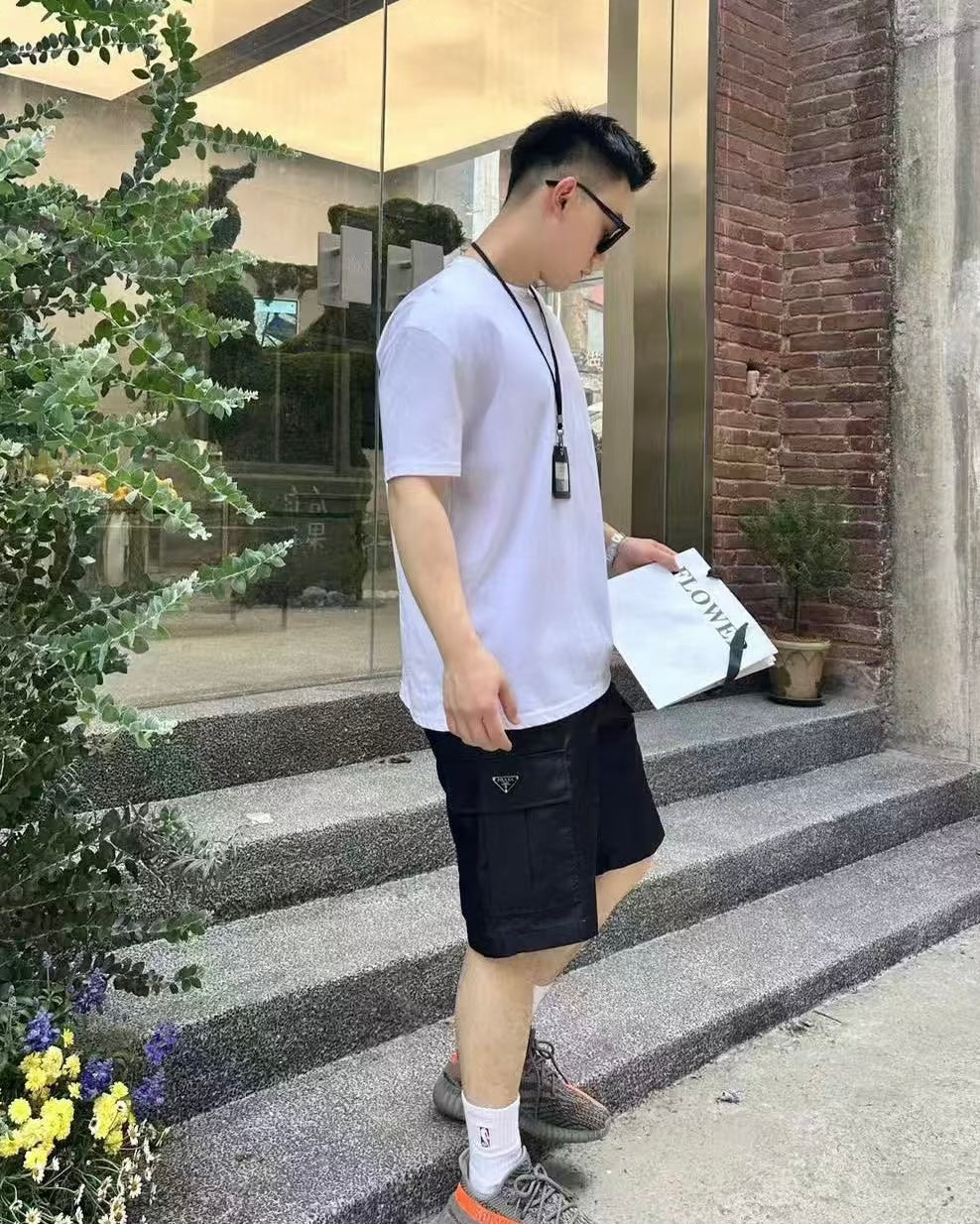 Prada black cargo shorts, above-knee length, side pocket detailing