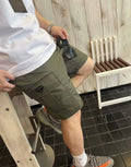 Olive cargo shorts with triangular logo patch and front hand pockets