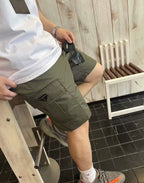 Olive cargo shorts with triangular logo patch and front hand pockets
