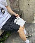 Prada black cargo shorts with side flap pockets and triangular logo