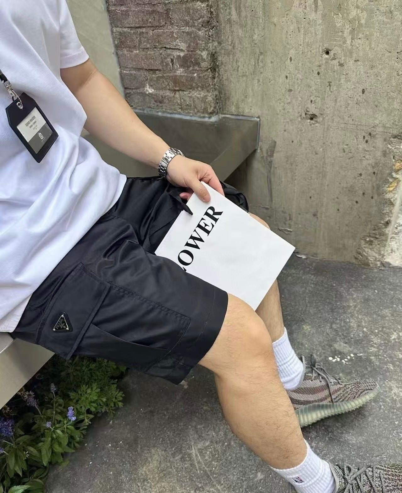 Prada black cargo shorts with side flap pockets and triangular logo