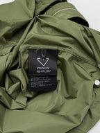Olive green short-sleeve zip jacket interior with PRADA RE-NYLON care label.