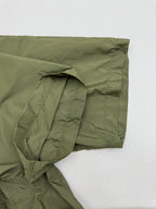 Olive green short-sleeve zip jacket sleeve with gathered fabric and side seam pocket.