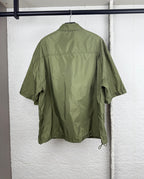 Olive green short-sleeve zip jacket, back view with yoke seams and relaxed fit.