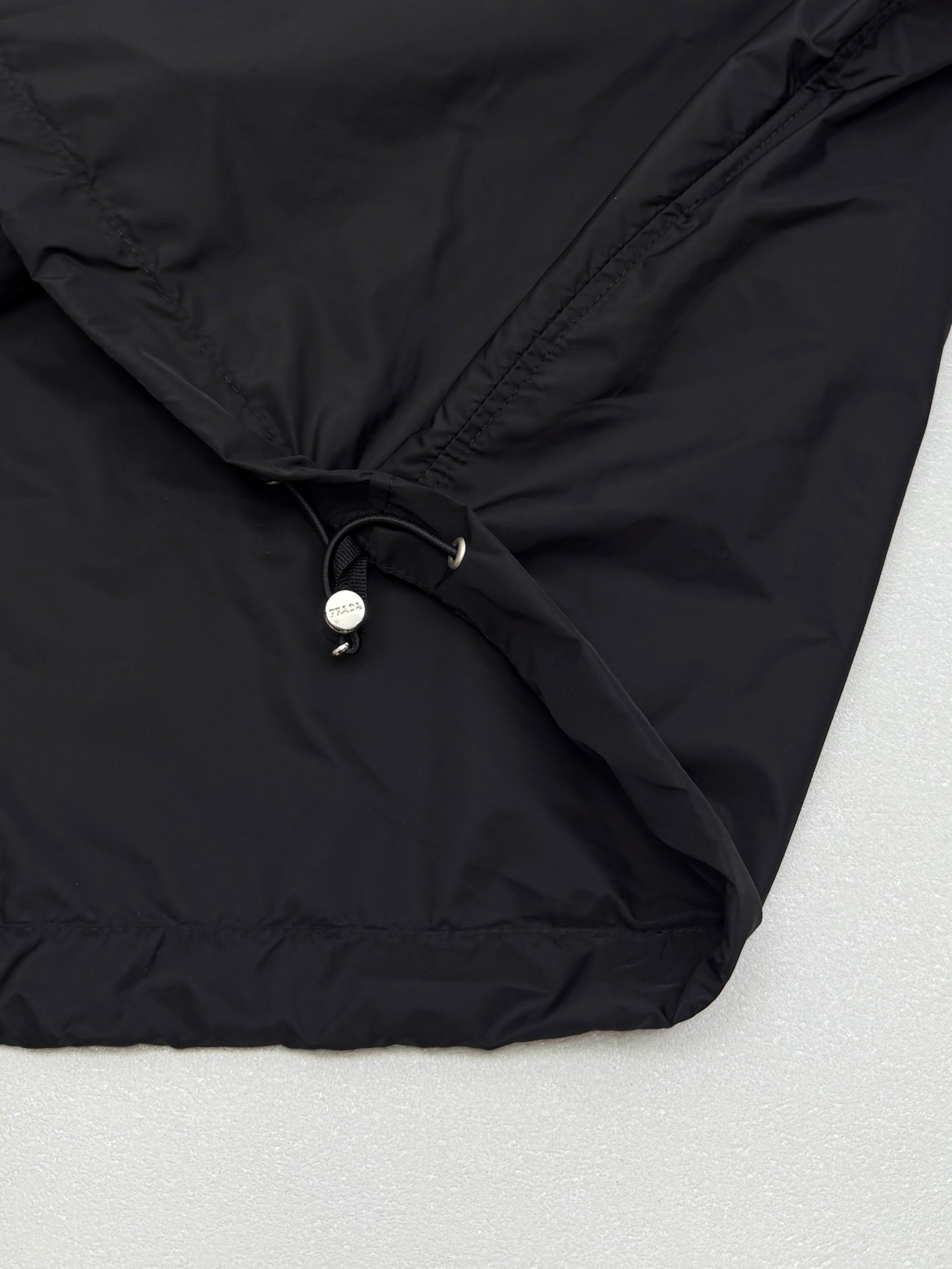 Prada short jacket hem with adjustable drawstring and metal toggle