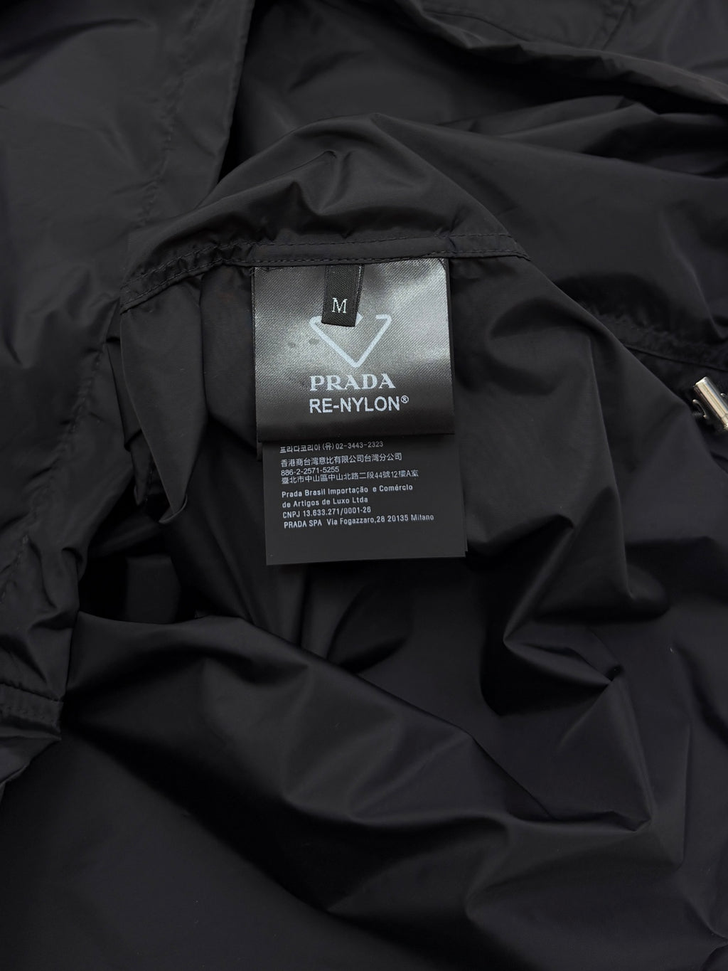 Prada short jacket interior care label with size M and PRADA RE-NYLON
