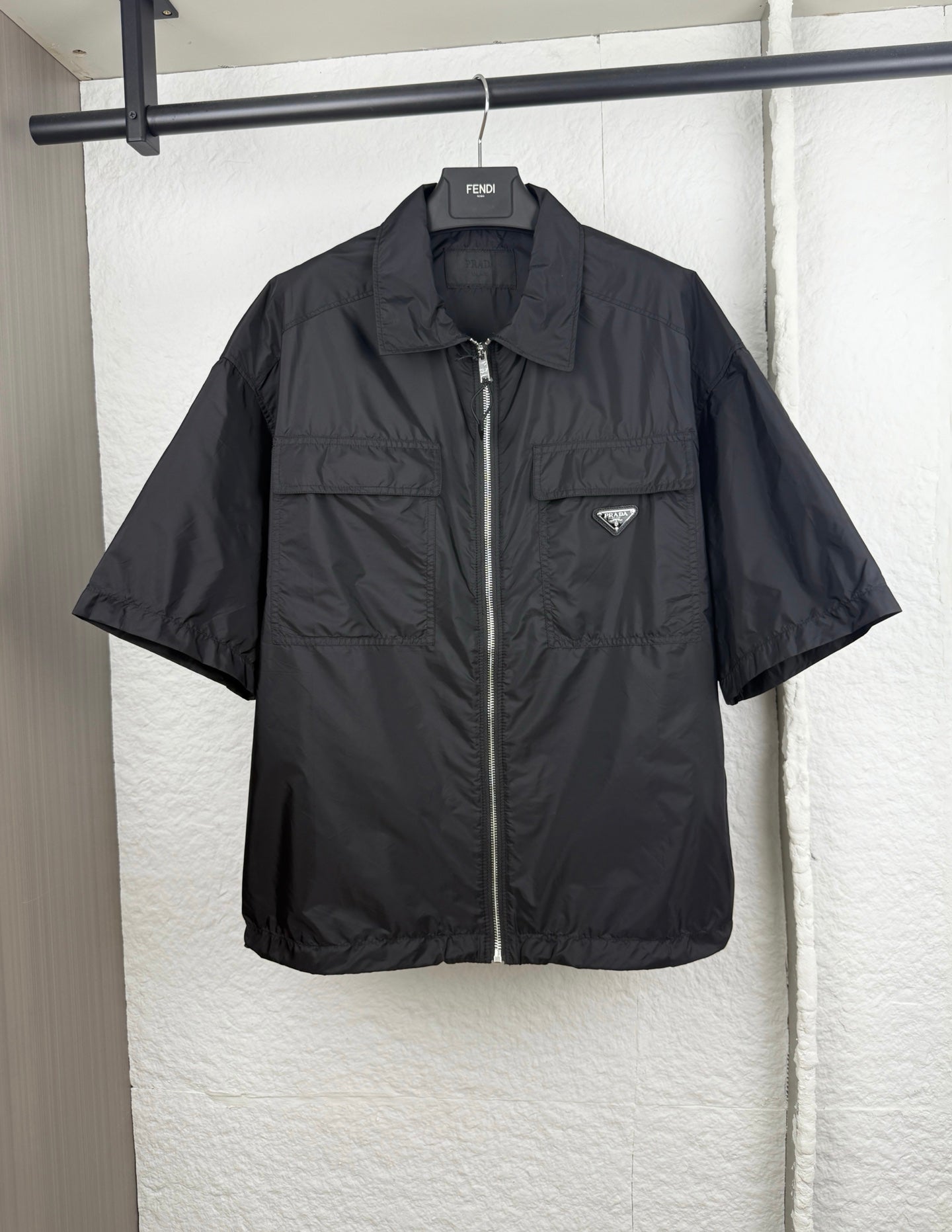 Prada short jacket in dark black with front zip and chest logo patch