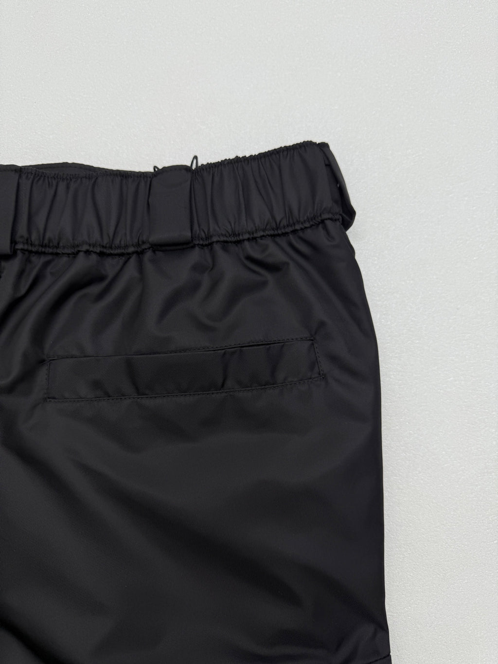 Prada black cargo shorts close-up of elastic waistband and stitching