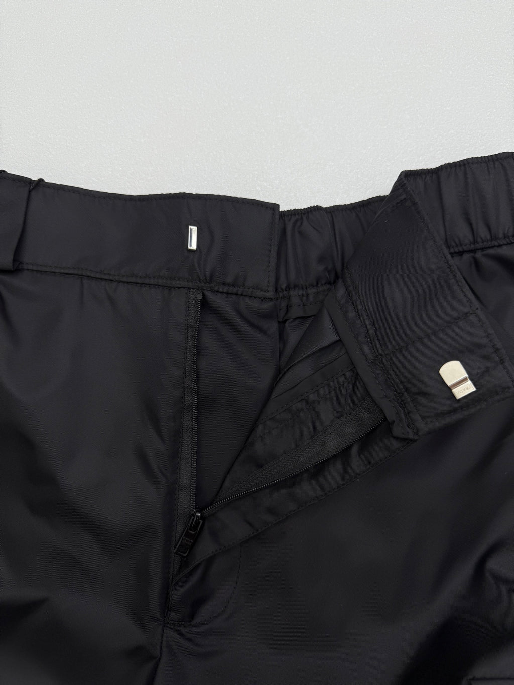 Prada black cargo shorts close-up of zip fly and inner pocket