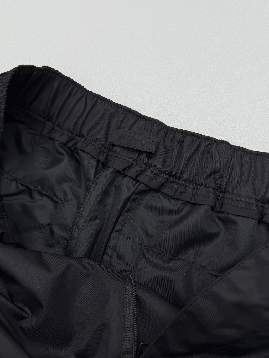 Prada black cargo shorts close-up of rear waistband and center seam