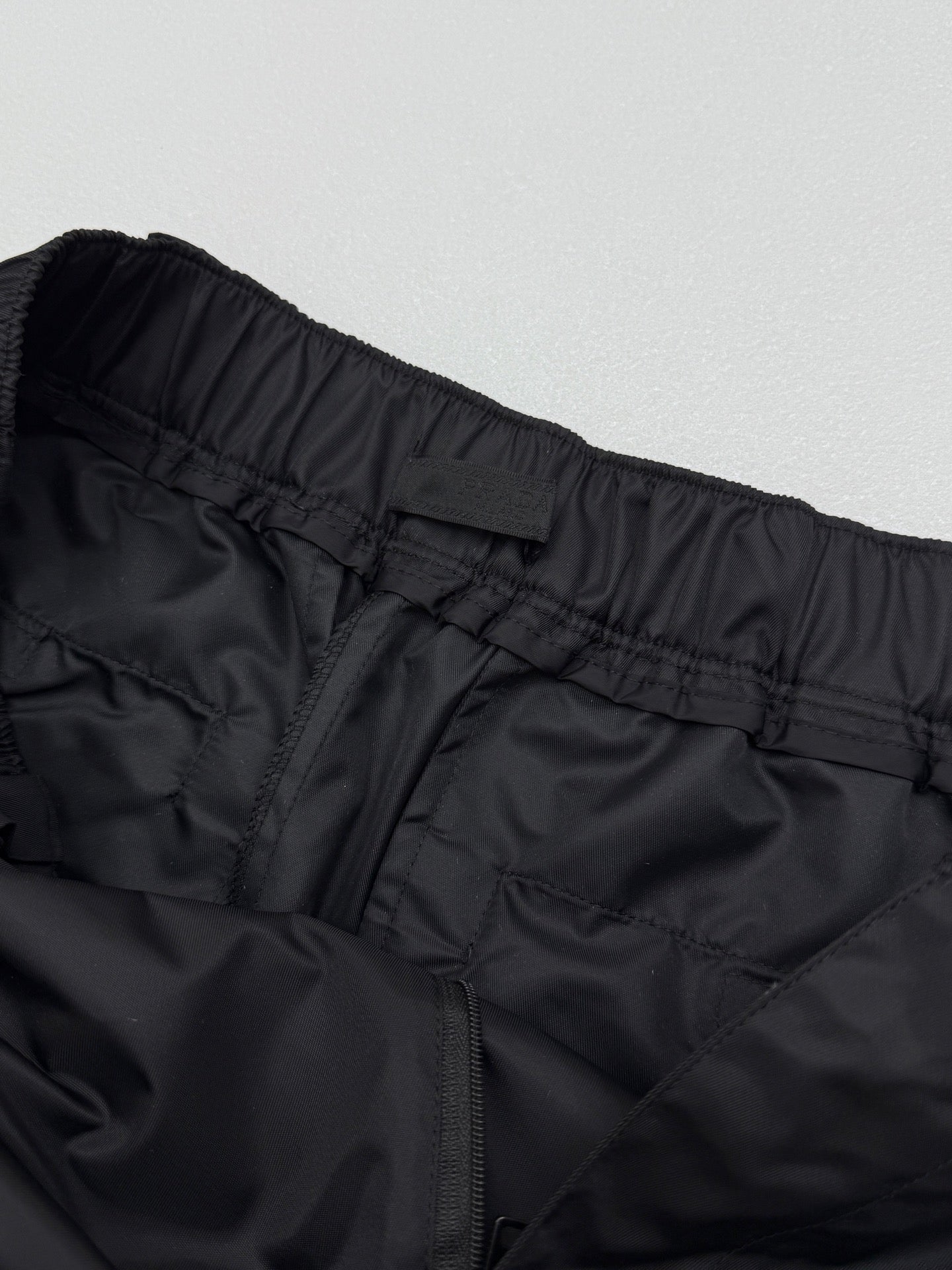 Prada black cargo shorts close-up of rear waistband and center seam