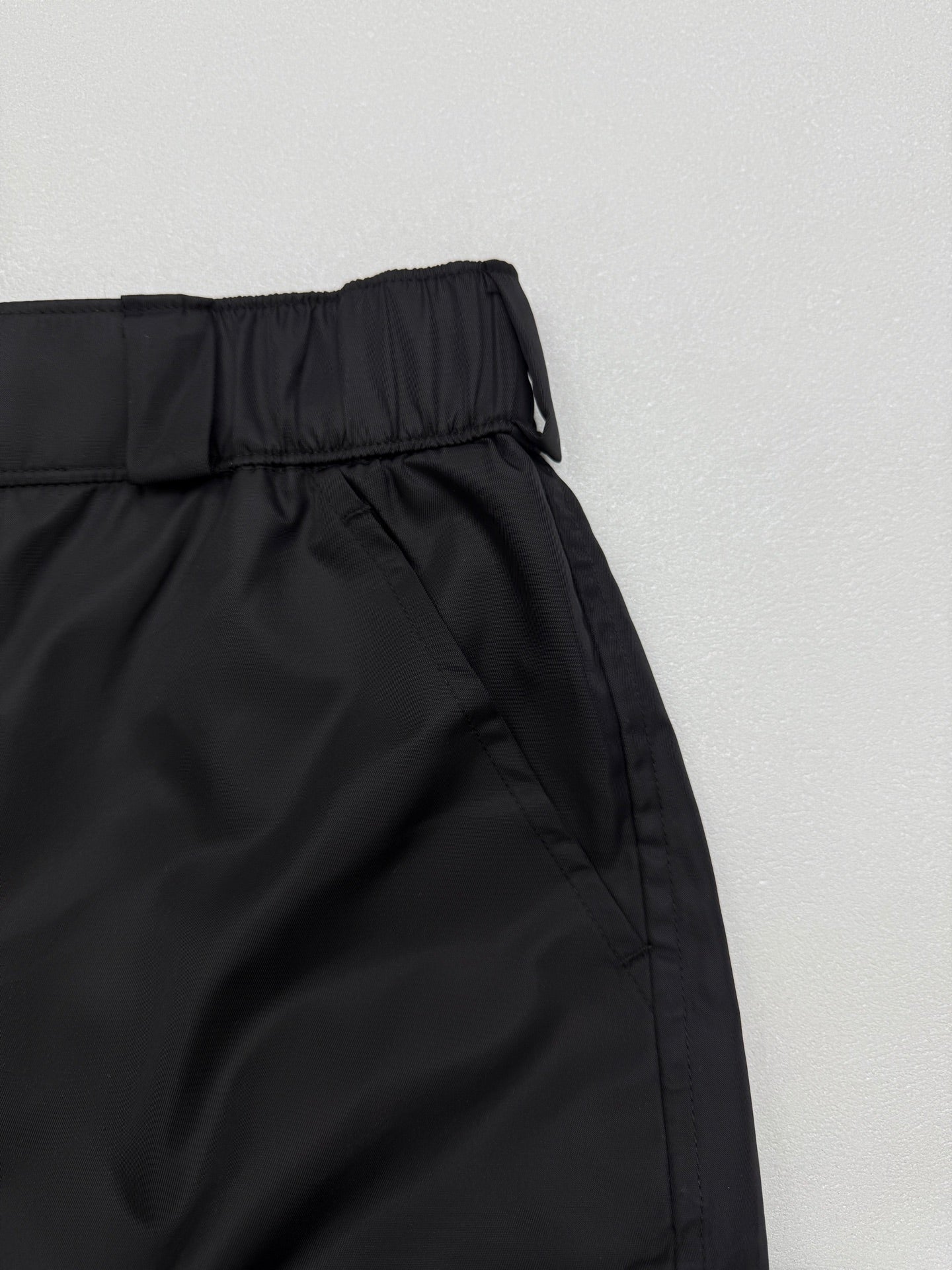 Prada black cargo shorts with elastic waistband and angled side seam