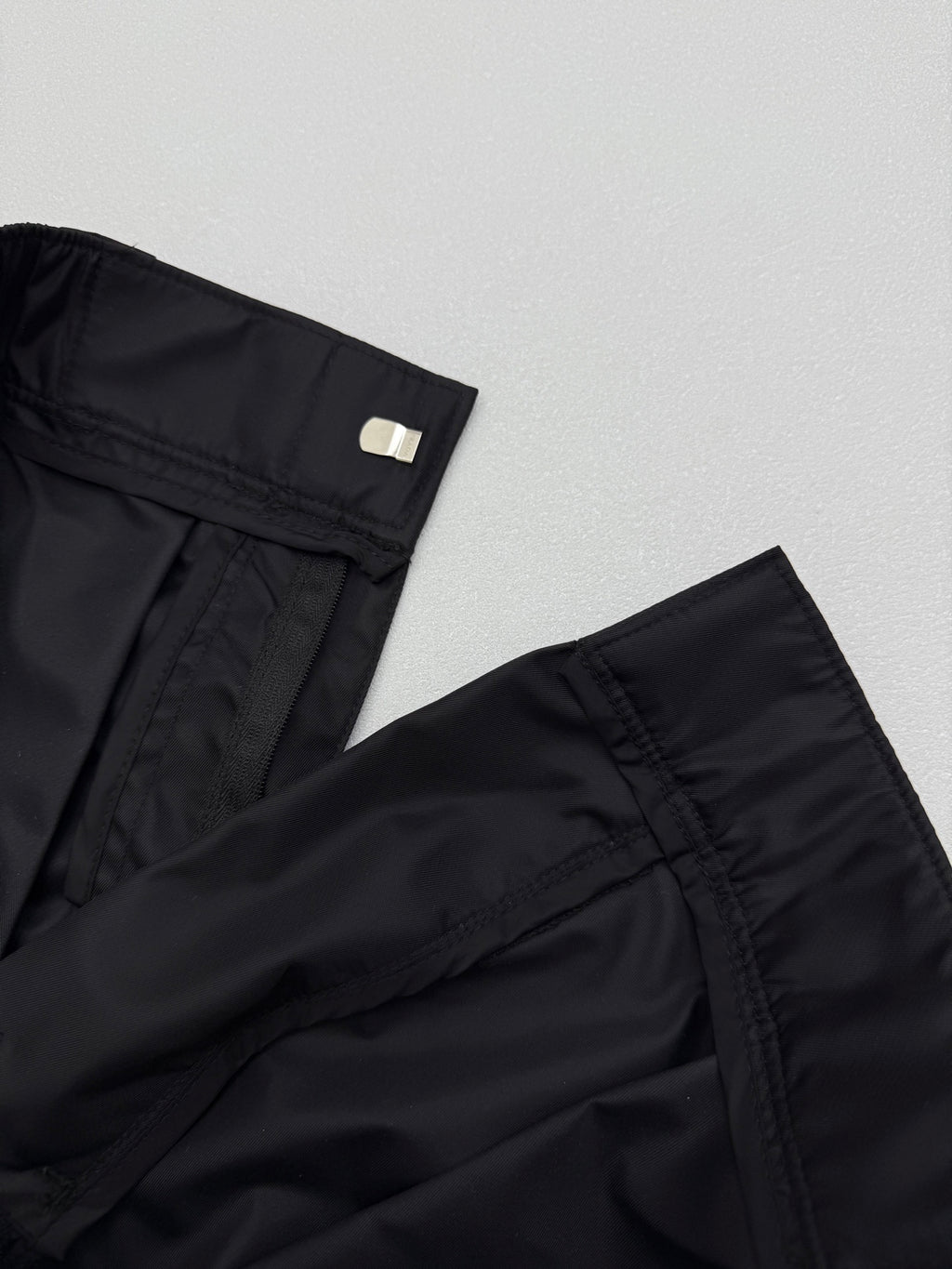 Prada black cargo shorts hem detail with side pocket stitching