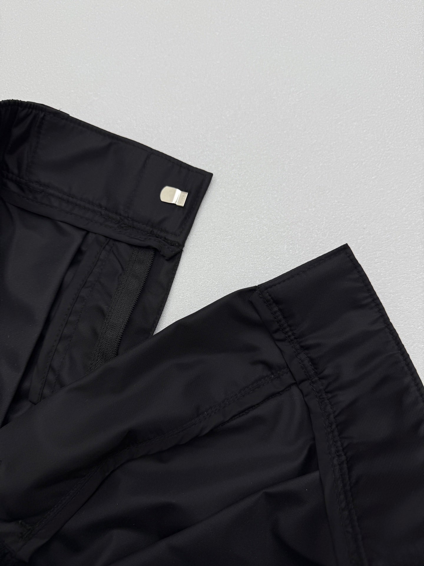 Prada black cargo shorts hem detail with side pocket stitching