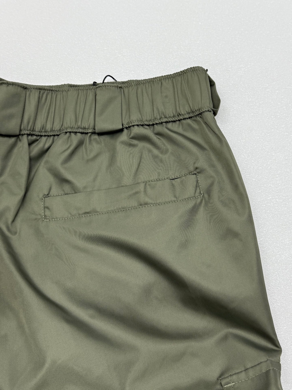 Olive cargo shorts with elastic waistband and stitched back seam