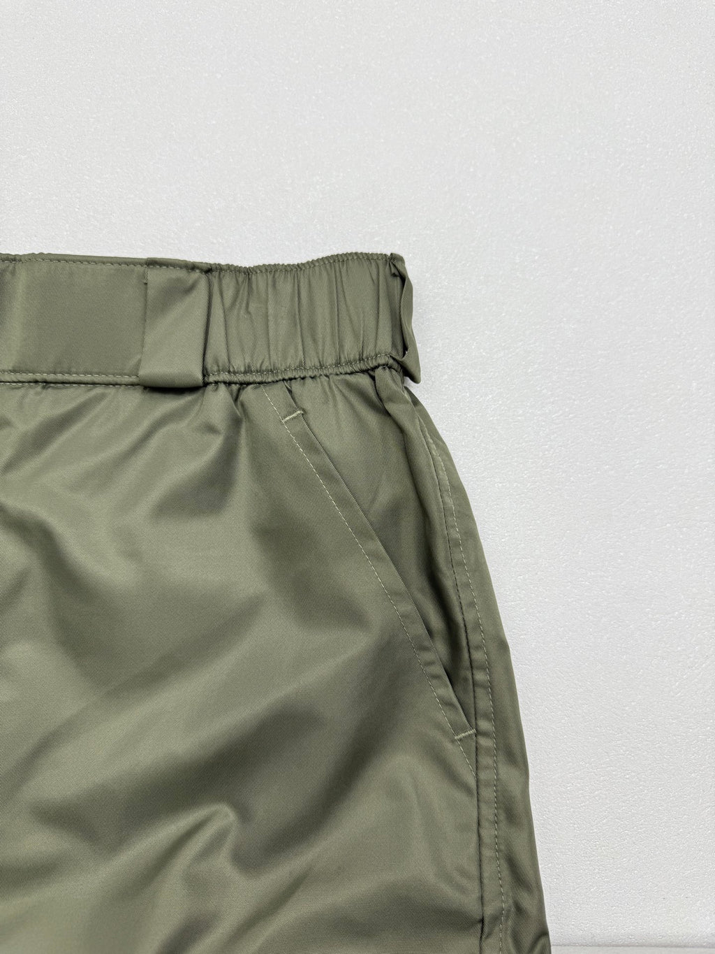 Olive cargo shorts with elastic waistband and stitched front panel