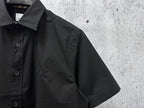 Black short-sleeve button-up shirt with logo embroidery and button placket
