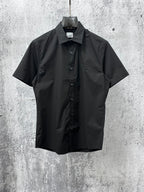 Black short-sleeve button-up shirt with spread collar and front button placket