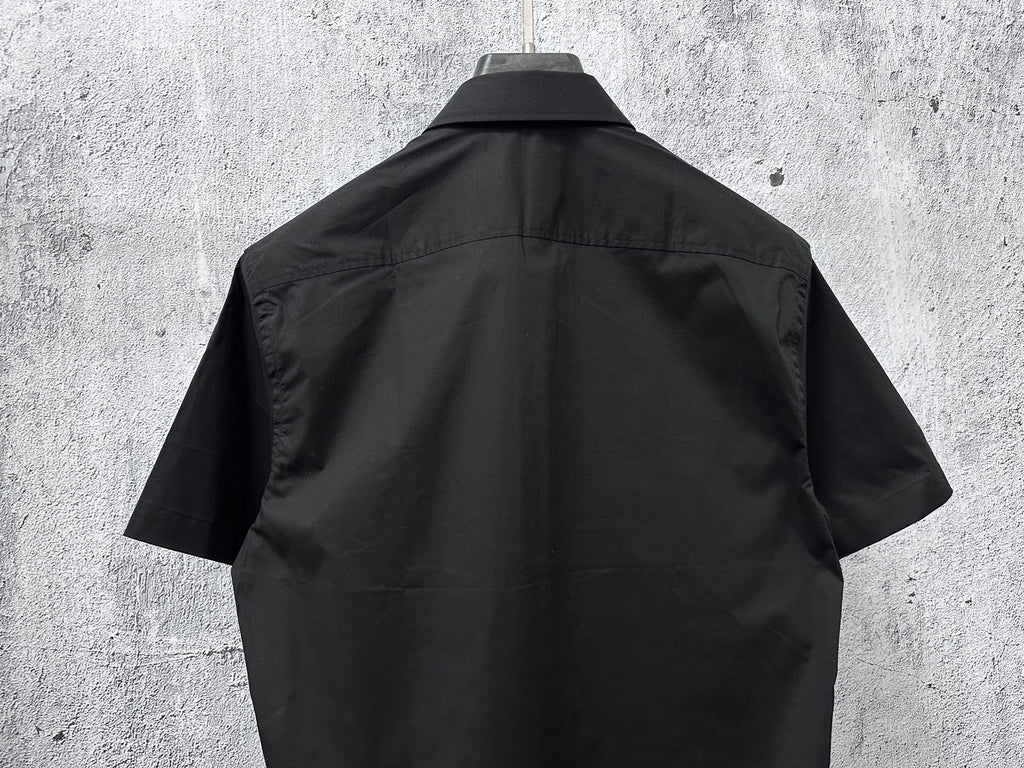Black short-sleeve button-up shirt, back view with yoke seam