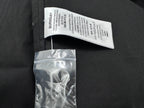 Burberry fabric care label attached to dark black shirt