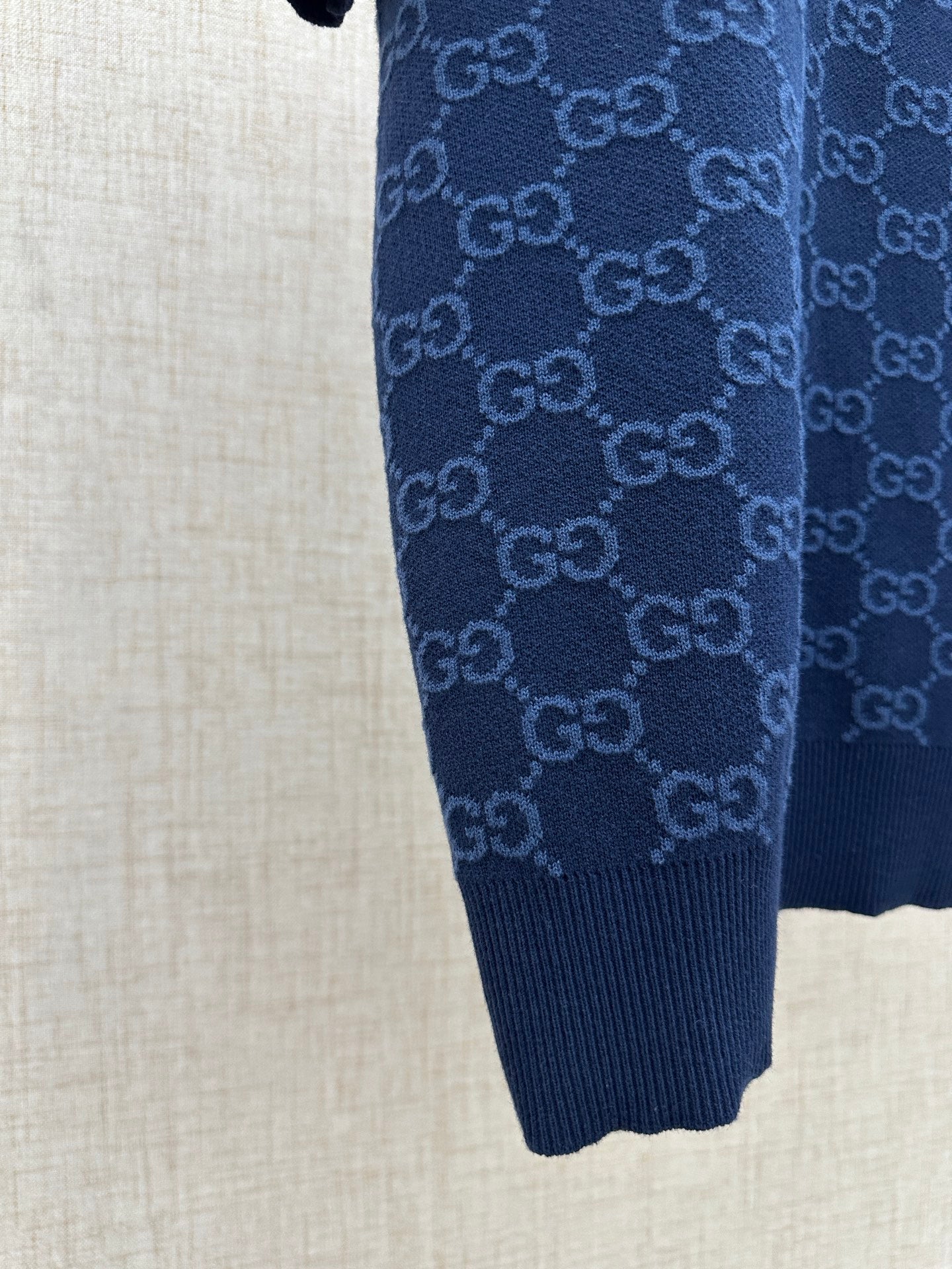 Dark navy polo shirt sleeve and hem, ribbed knit cuffs and bottom