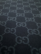 Dark navy knit fabric with repeating GG monogram motif