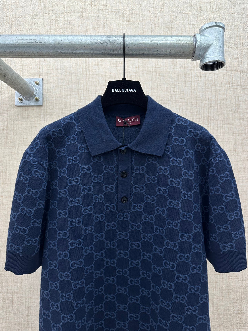 Dark navy polo shirt with GG monogram pattern, collared neckline and button front