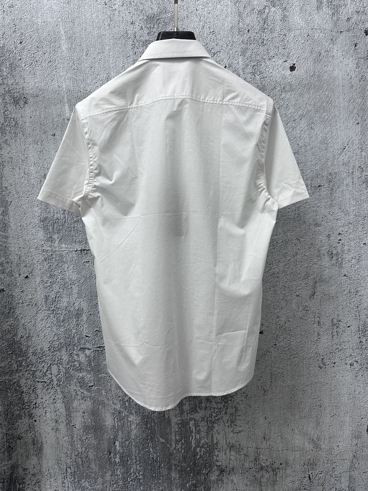White short-sleeve button-up shirt back view with yoke seam and short sleeves