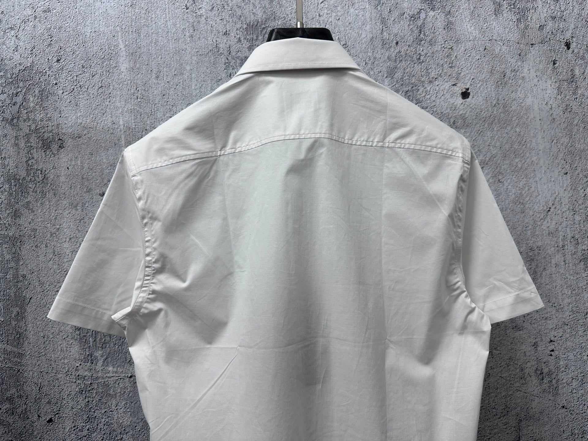 White short-sleeve button-up shirt back view with center seams