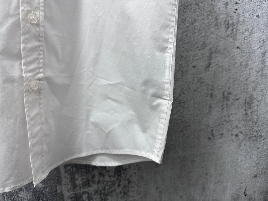 White short-sleeve button-up shirt lower front with curved hem