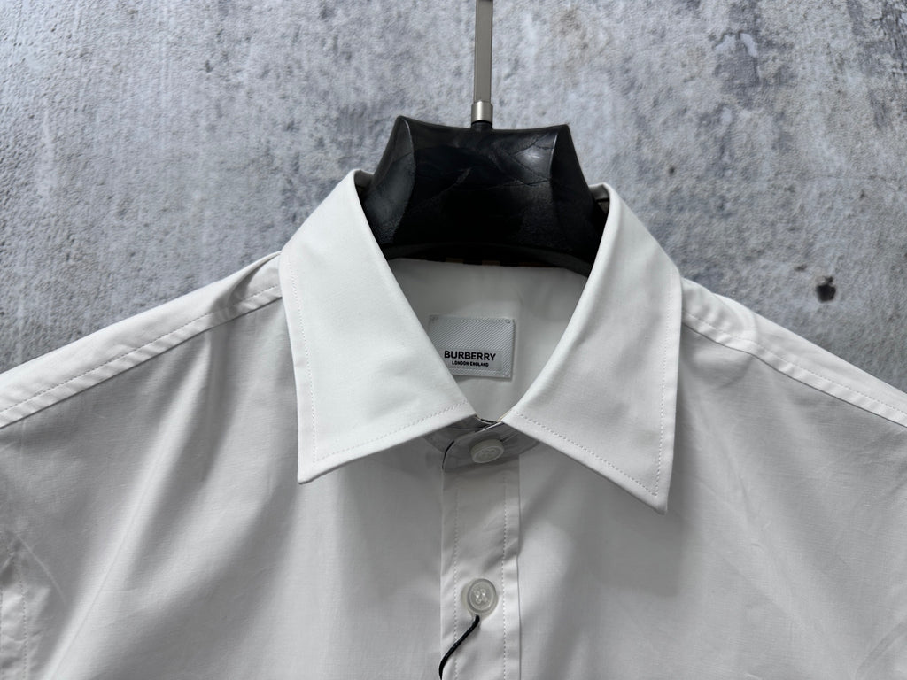 White Burberry short-sleeve shirt neckline with pointed collar and button detail