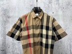 Burberry short-sleeve button-up shirt front, beige black white plaid with red accents