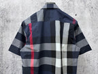 Short-sleeve button-up shirt back in navy, white, gray and red plaid