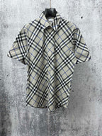 Burberry short-sleeve button-up shirt in black, white, and light blue plaid