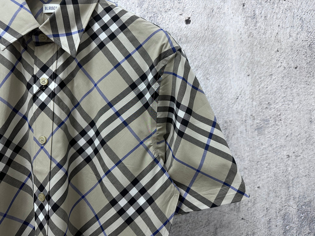 Burberry short-sleeve plaid shirt close-up, buttoned front; beige, blue, and black check