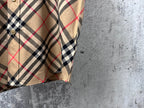 Plaid short-sleeve button-up shirt, side view with sleeve and curved hem