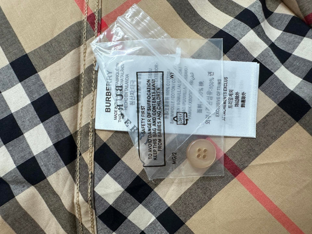 Burberry plaid shirt interior care label with beige button