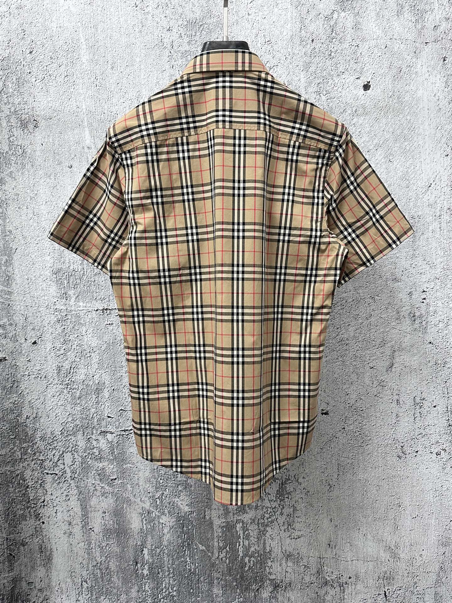Burberry plaid short-sleeve shirt back view on hanger with check pattern