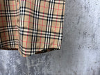 Burberry plaid short-sleeve shirt hem view with side seam and button line
