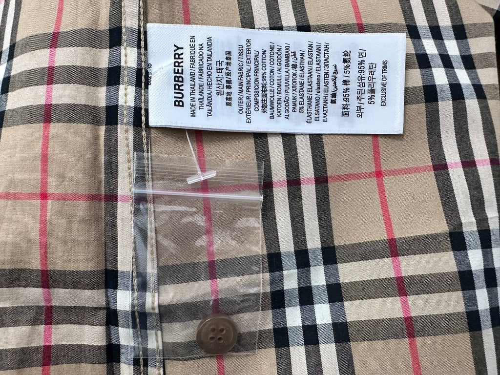 Burberry care label and fabric tag on plaid shirt front