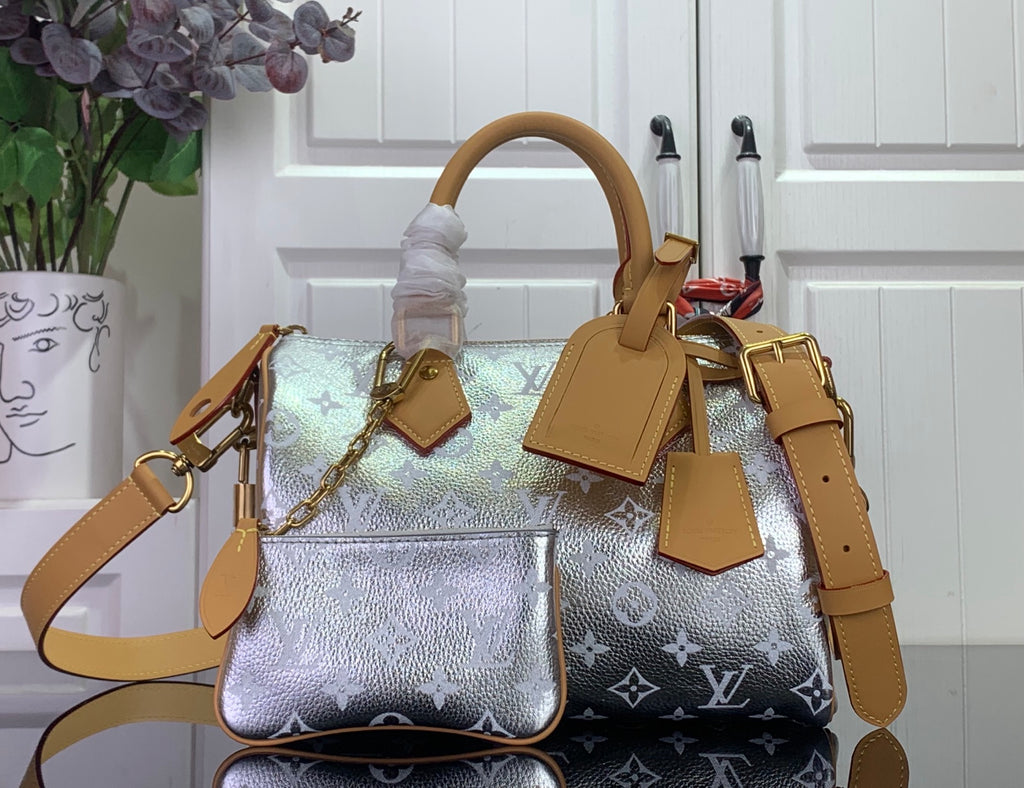 Louis Vuitton handbag with silver monogram canvas, tan leather straps and gold hardware