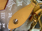 Louis Vuitton strap attachment in tan leather with engraved brand and gold buckle