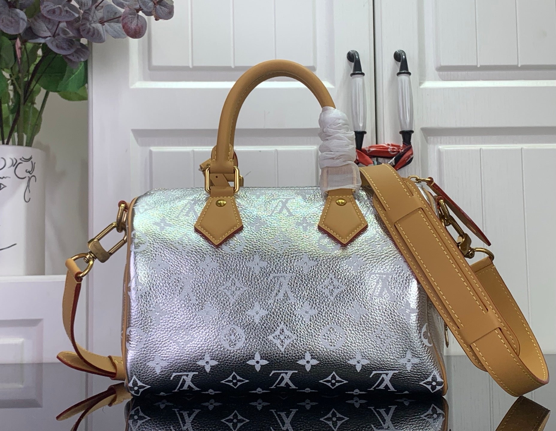 Louis Vuitton top-handle handbag with silver monogram canvas and tan leather wrist strap