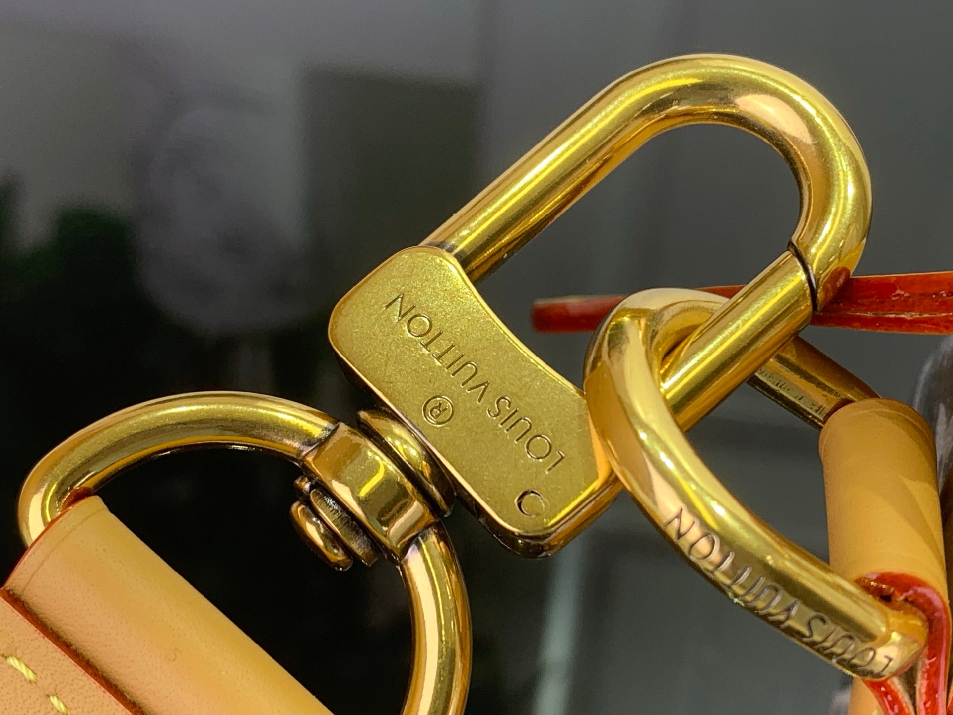 Louis Vuitton padlock detail in gold tone on bag hardware
