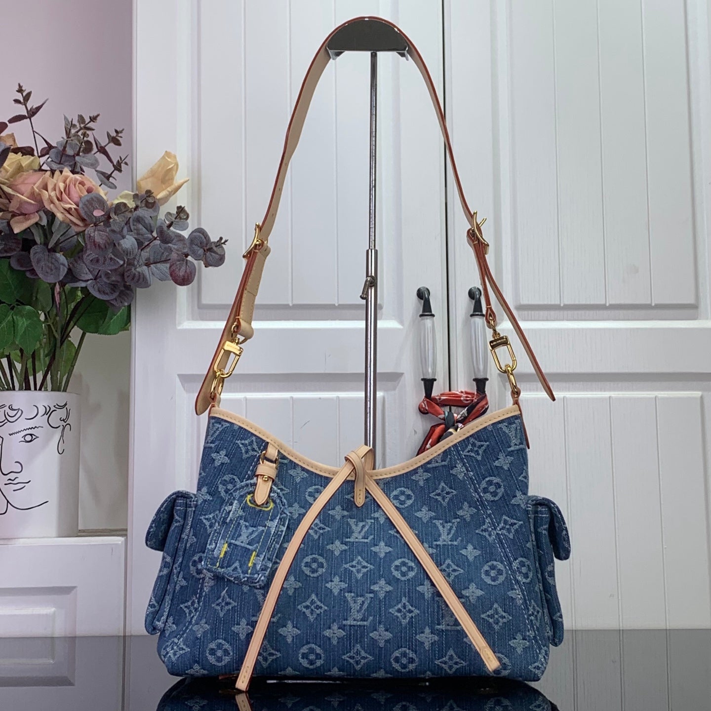 Louis Vuitton denim monogram shoulder bag with tan handles and gold hardware