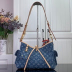 Monogram tote bag in blue denim with tan trim and gold hardware, top handles