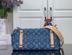 Denim monogram satchel top with tan flap, gold snaps, and side straps
