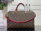 Monogram top-handle bag with burgundy handles and gold side hardware
