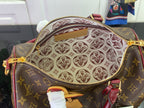 Monogram bag interior with patterned lining, zipper edge, and burgundy strap