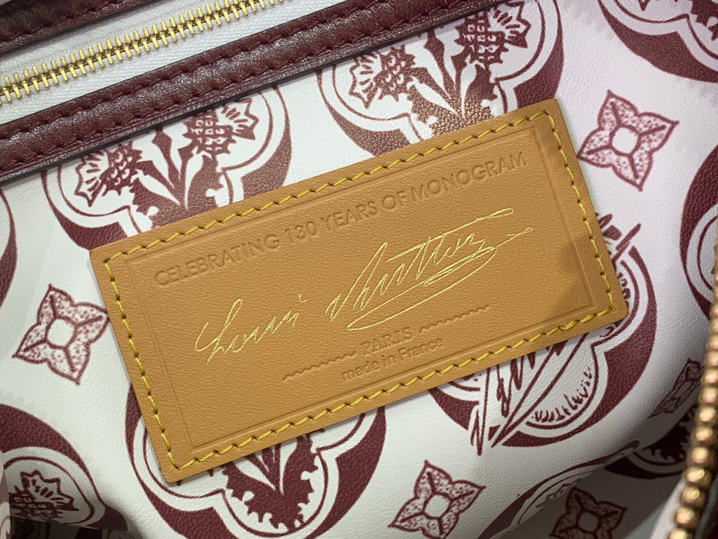 Leather card holder label on patterned lining inside monogram bag